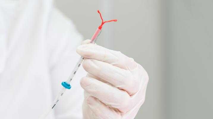Doctor holding an IUD