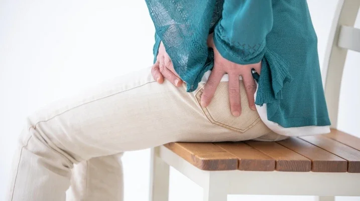 Woman holding hip in pain
