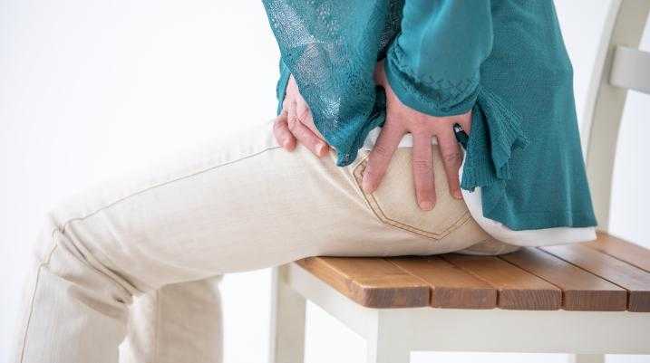 Woman holding hip in pain
