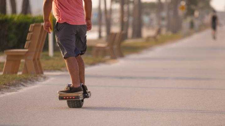 Man riding on a one-wheel skateboard