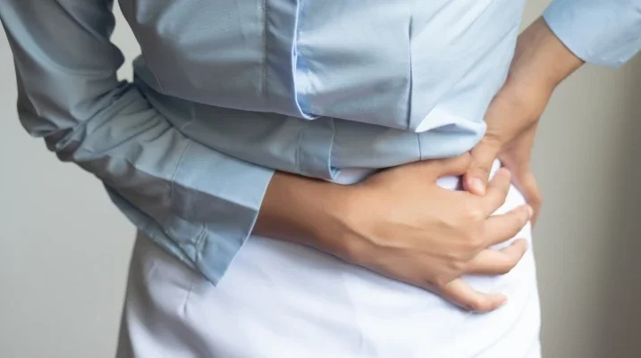 Woman holding hip in pain