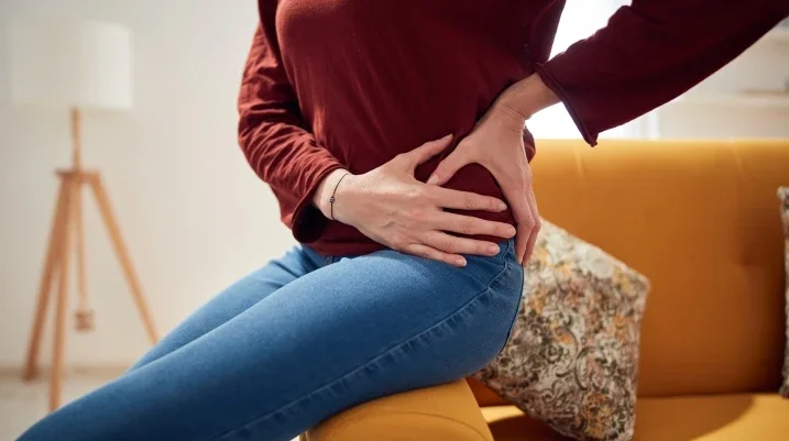 Woman holding hip in pain