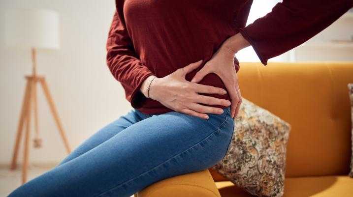 Woman holding hip in pain