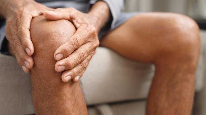 Man holding knee in pain 