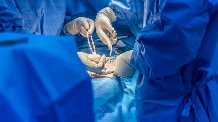 Surgeons using medical mesh