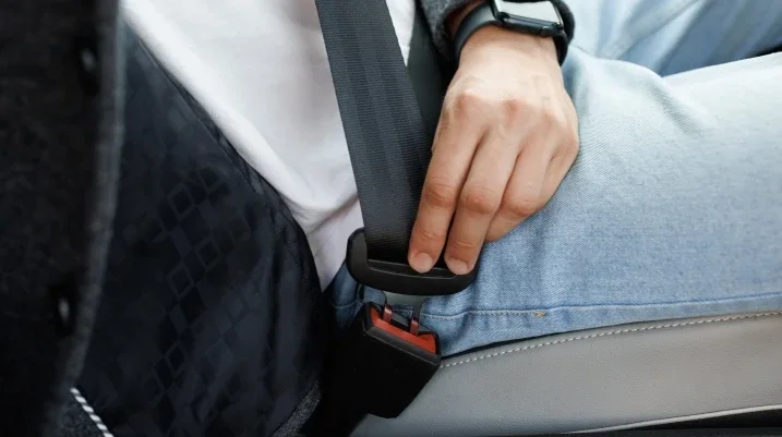 Man fastening a seat belt