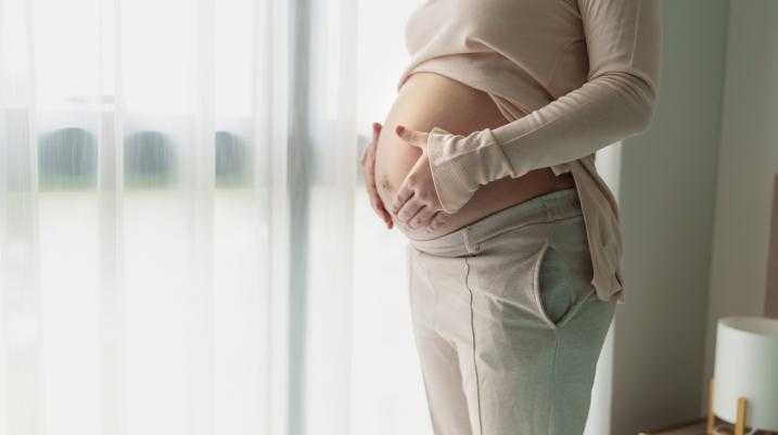Pregnant woman holding her stomach
