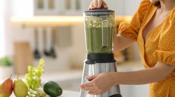 Woman using a blender