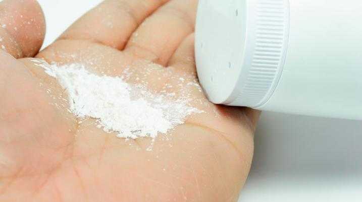 Person putting talcum powder in their hand