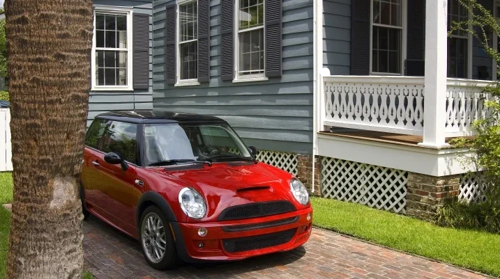 Mini Cooper parked next to a house