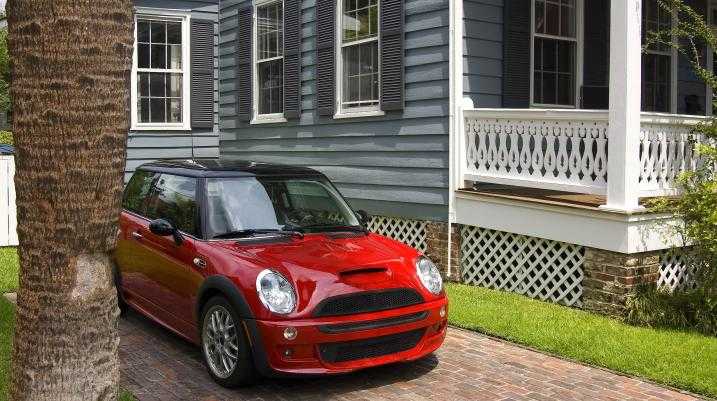 Mini Cooper parked next to a house