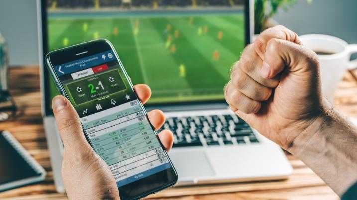 Person sports betting on cellphone 