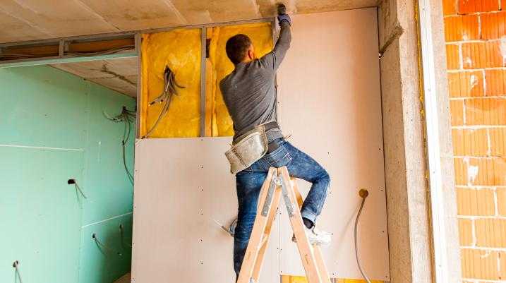 Man putting up dry wall