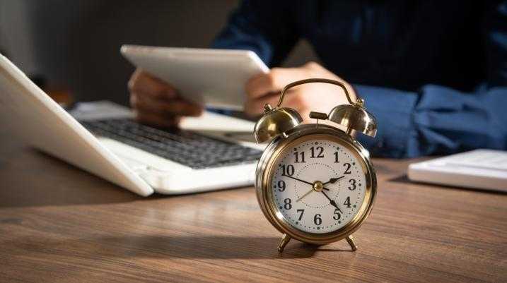 clock near a laptop