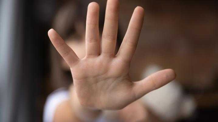 hand reflecting that she's saying no