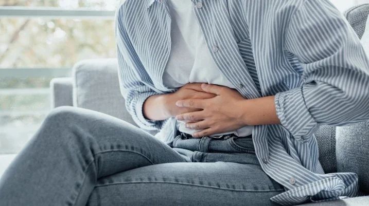Woman holding stomach in pain