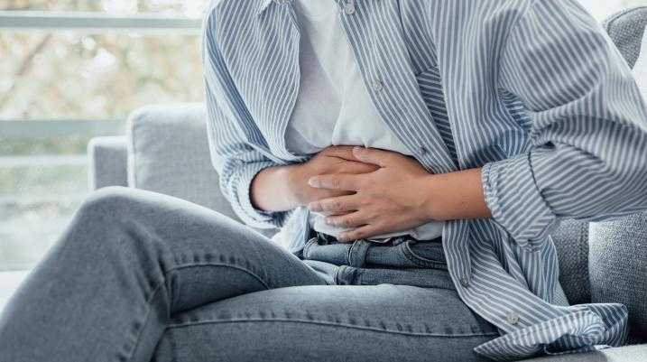 Woman holding stomach in pain