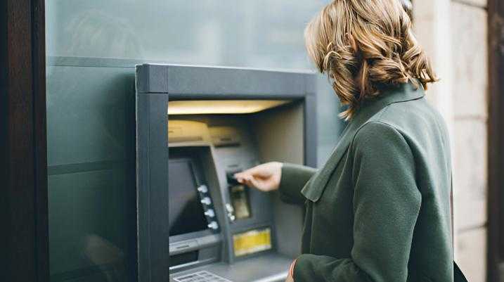 Woman using ATM