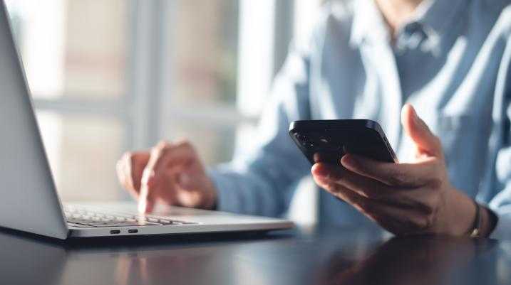 Person using laptop and phone
