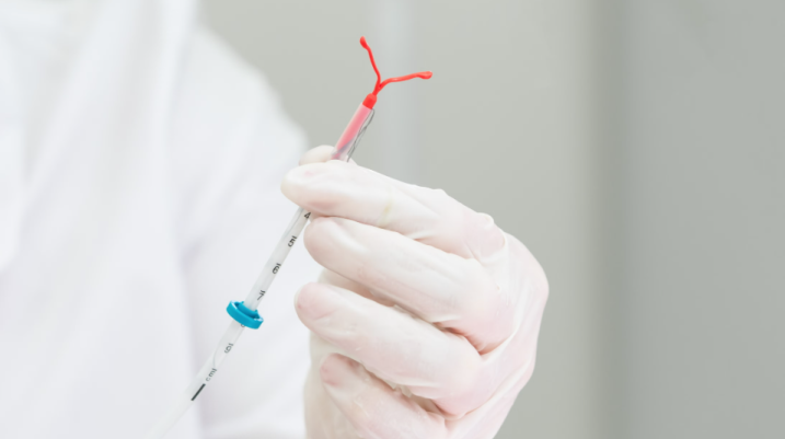 Doctor holding an IUD