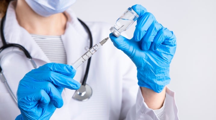 Doctor using a steroid needle