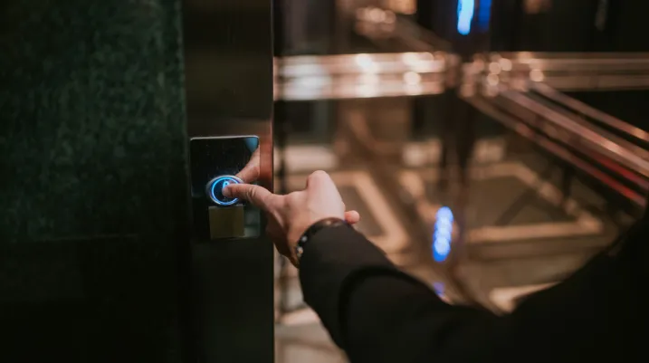 Businessman's finger on the elevator button