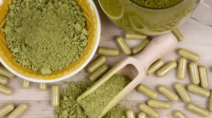 Kratom Mitragyna speciosa powder, capsule and drink top view stock images. Green kratom powder, capsule and beverage still life above stock photo. Kratom herbal medicine stock images