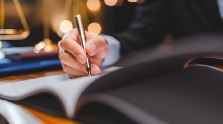 lawyer signing contract with client 