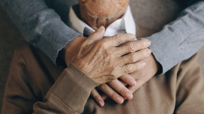 Old man being hugged
