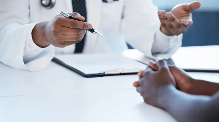Healthcare, clipboard and hands of doctor with patient for discussion, treatment and medical service. Hospital, clinic and health person with paperwork for insurance, wellness and consulting report