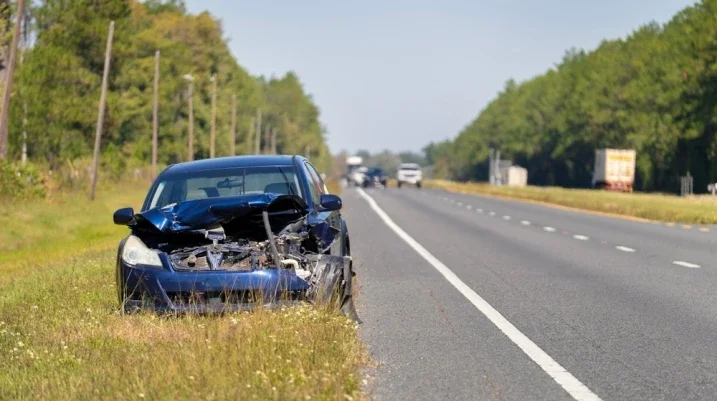 damaged car on the side of the road