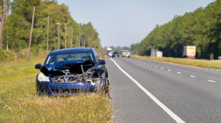 damaged car on the side of the road