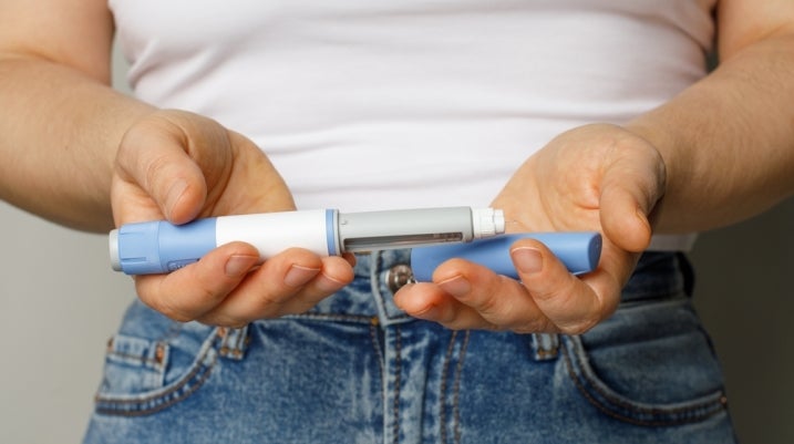 person holding two vaccines