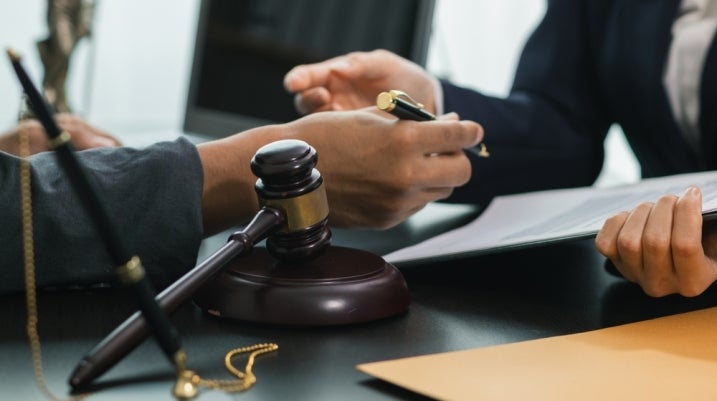 client with their lawyer in a courtroom