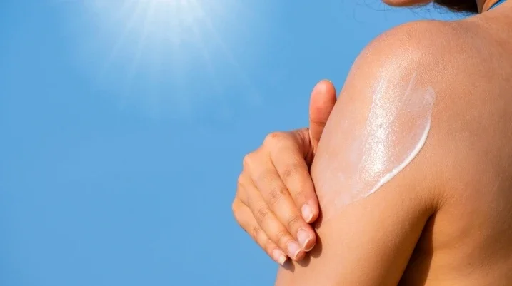 Woman applying sunscreen