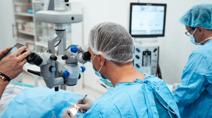 Skilled surgeon and his medical team perform precise eye surgery on an elderly patient, restoring vision with latest medical technology and cutting-edge techniques. Modern eye surgery concept.
