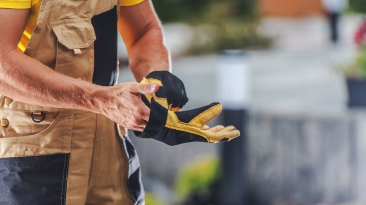 construction worker putting on a glove