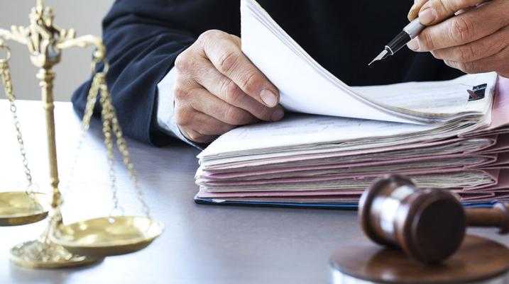 Florida Supreme Court to Vote on Changing the Rules of Evidence - lawyer writing on a book