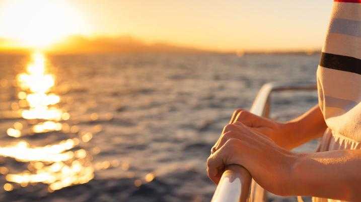 Mobile Is About to Get a Lot of Cruise Ship Traffic - A person's hand grasps the railing of the cruise ship