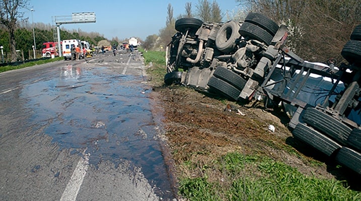 Crash truck tipped over on side of road
