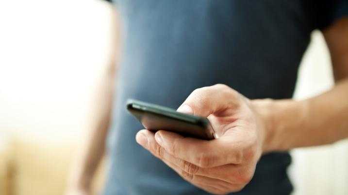 phone in hand using Facebook