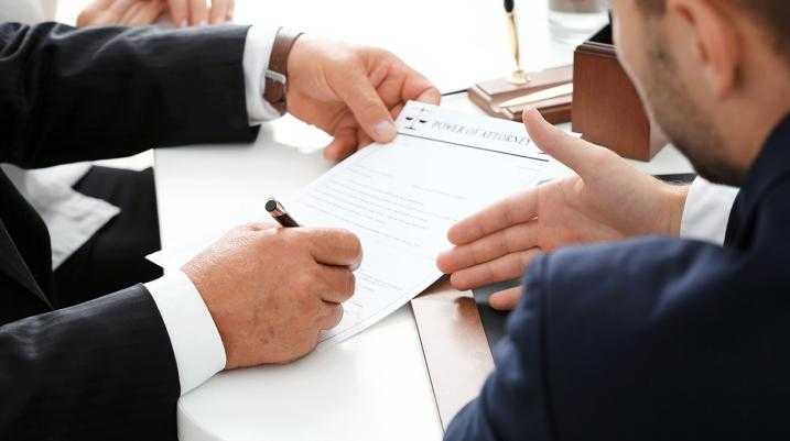 Man pointing at paper being written on