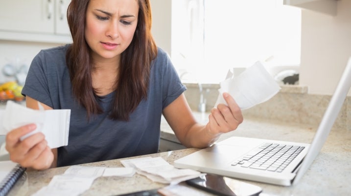 stressed woman looking at life insurance policy