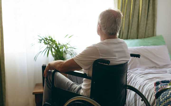 Elderly man sitting in wheelchair
