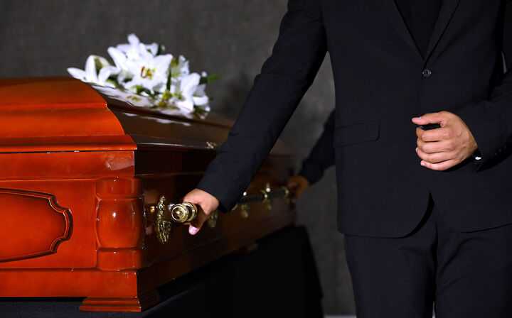 Men in suits holding casket