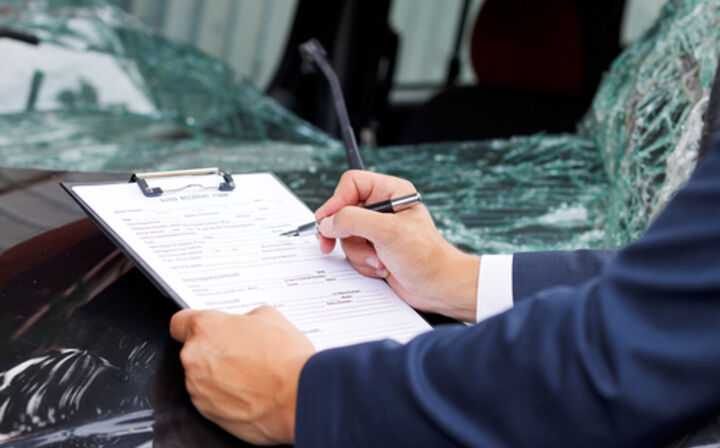 Accident Claim Lawyers - lawyer filling out accident claim paperwork