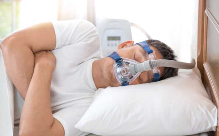 Are ResMed CPAP Machines Being Recalled - person sleeping with cpap machine