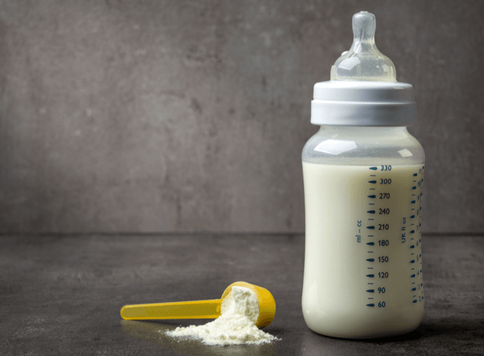 bottle of baby milk on dark grey table