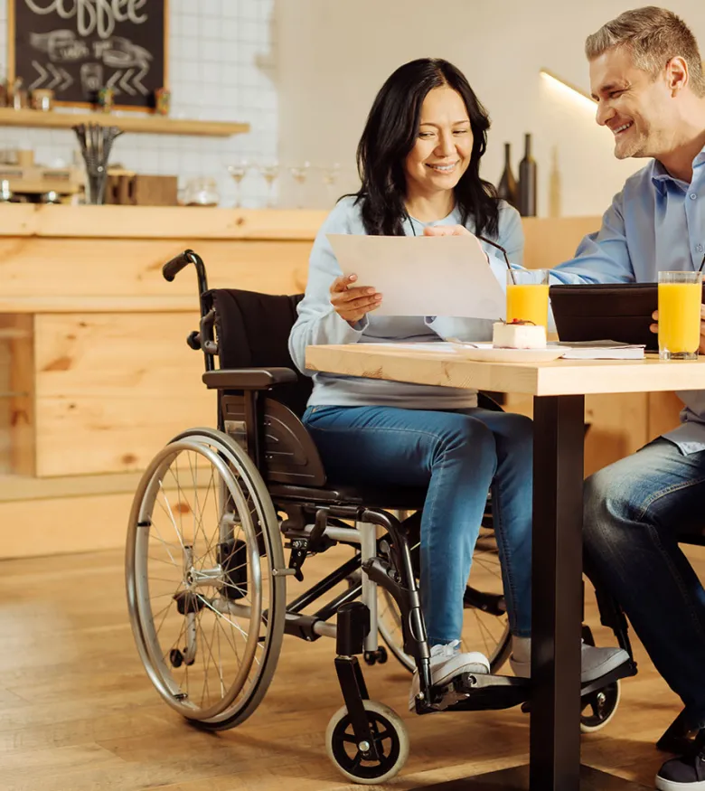 Social Security Disability Lawyers in Newark, New Jersey (NJ) - Woman in wheelchair talking to man about papers