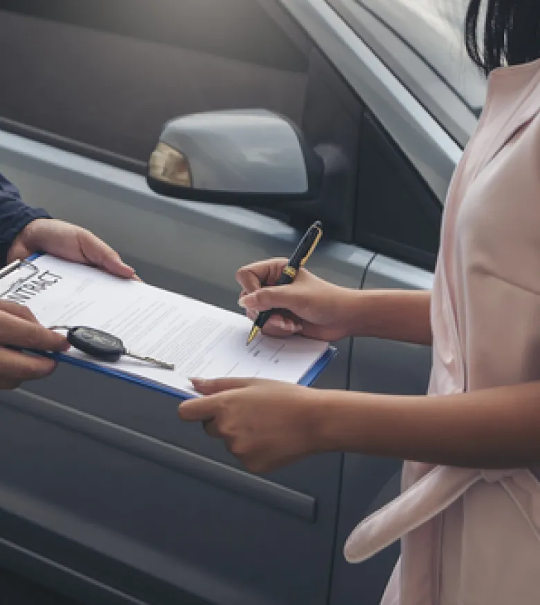 Where Can I Find the Best Car Insurance Attorney in Gainesville, FL? - Woman signing car insurance paperwork